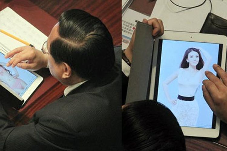 Albert Ho, anggota parlemen Hong Kong ketahuan menonton foto seksi saat rapat.