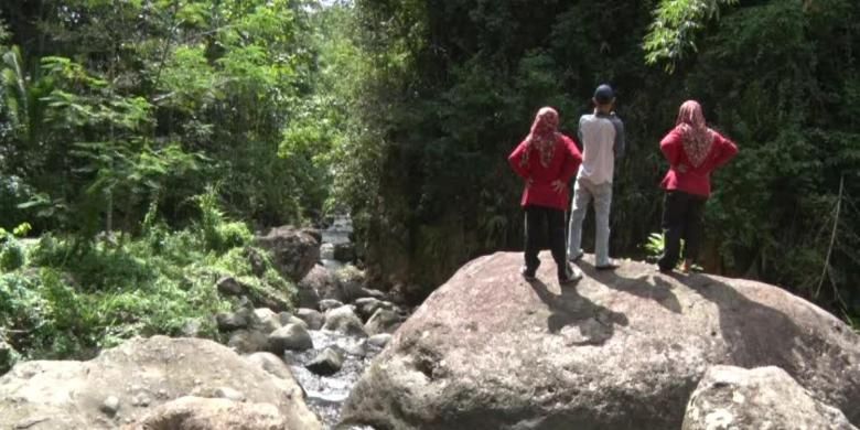 Wisatawan menikmati pemandangan sungai berbatu di kawasan di desa wisata Sawahan, Kecamatan Watulimo, Kabupaten Trenggalek, Jawa Timur.