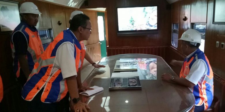 Pintu berikutnya akan mengantar Anda pada sebuah ruangan rapat yang mana terdapat sebuah meja besar. Meja tersebut dikelilingi oleh beberapa kursi dan difasilitasi sebuah televisi.