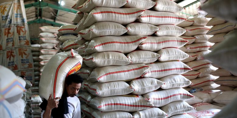Buruh menurunkan beras Bulog di Pasar Induk Beras Cipinang, Jakarta Timur, Rabu (26/7/2017). Penetapan Harga Eceran Tertinggi (HET) untuk komoditas beras memberikan pengaruh yang besar kepada para petani dan pedagang sehingga menyebabkan pasokan beras ke pasar induk anjlok.