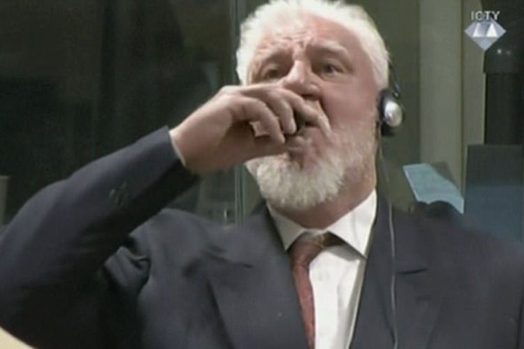 Terpidana tindak kejahatan perang Bosnia Slobodan Praljak (72) menenggak cairan dari botol kecil di hadapan persidangan.