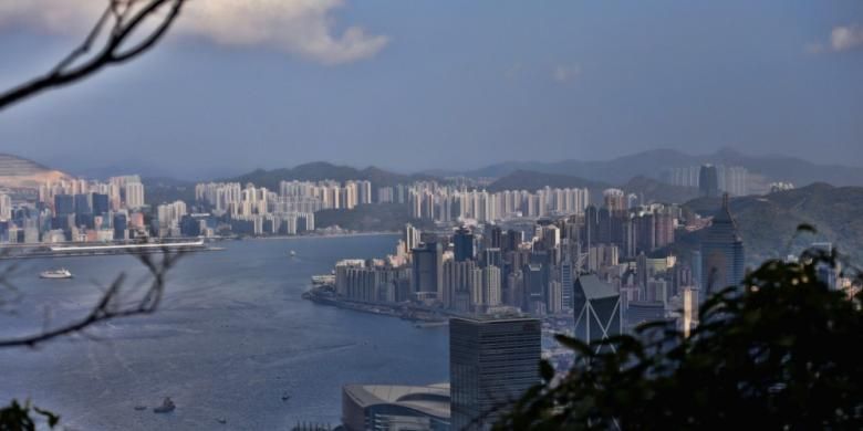 Pemandangan Kota Hongkong. Hongkong saat ini memiliki populasi sekitar tujuh juta penduduk dan bangunannya didominasi dengan rusun atau apartemen.