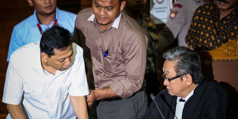 Tersangka kasus korupsi proyek e-KTP, Setya Novanto berbicara dengan penasehat hukumnya pada sidang perdana di Gedung Pengadilan Tipikor, Jakarta, Rabu (13/12/2017). Setya Novanto akan menghadapi sidang pembacaan dakwaan oleh jaksa penuntut umum.